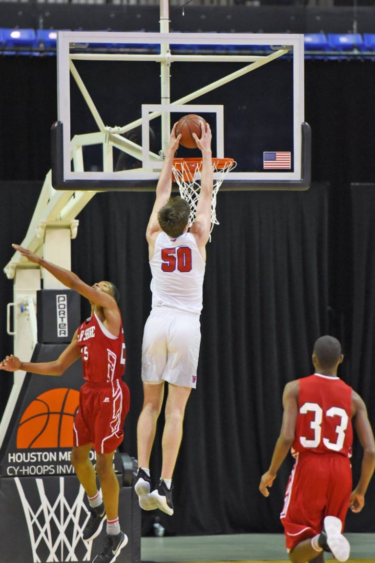 Offensive player dunks over defender.